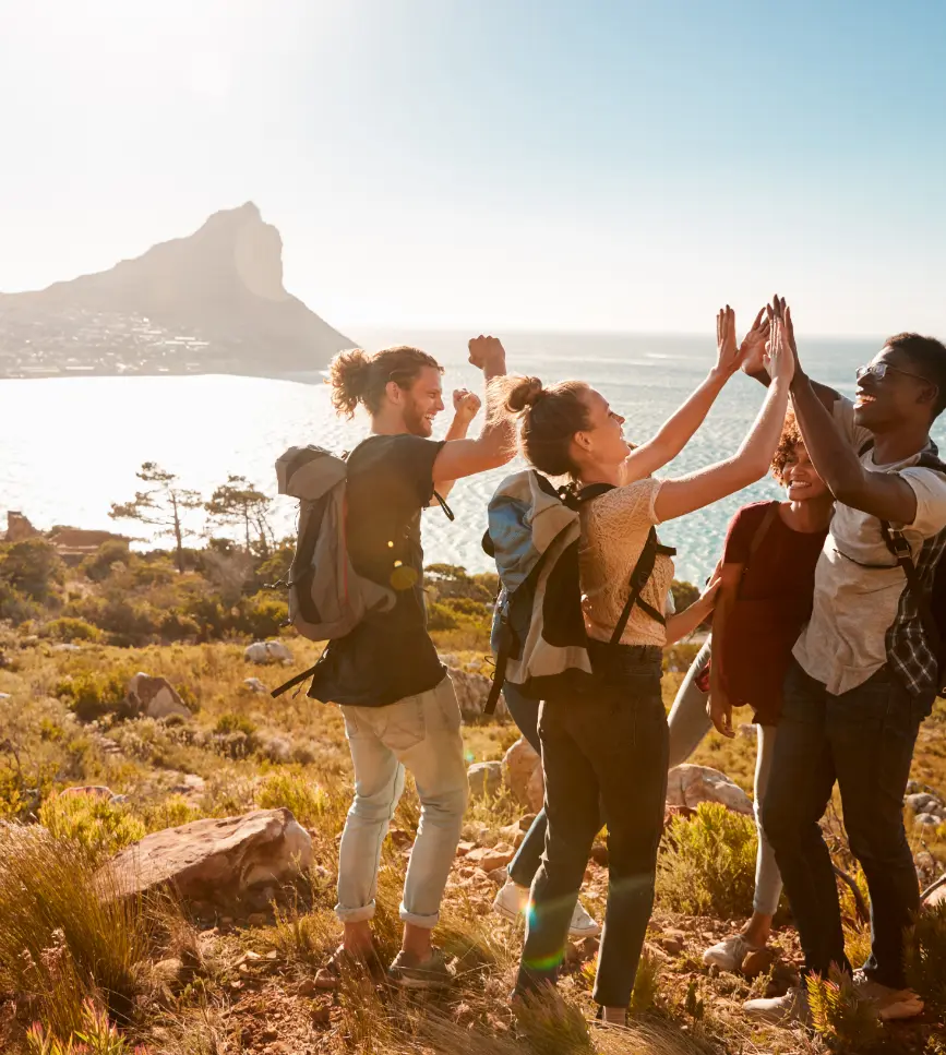 A group of friends finishing a hike by the beach