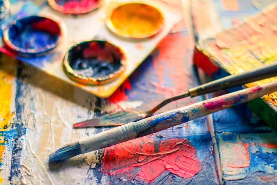 Expressive Art Therapy at Villa Oasis San Diego: paint palette and paint brushes sit on a wooden table with paint on it